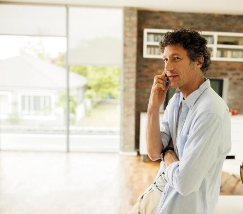 Man-standing-in-office-at-mobile-phone-teaser